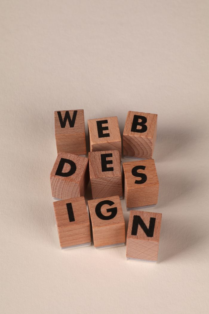 services-02 Wooden blocks arranged to spell Web Design. Perfect for creative, digital content themes.